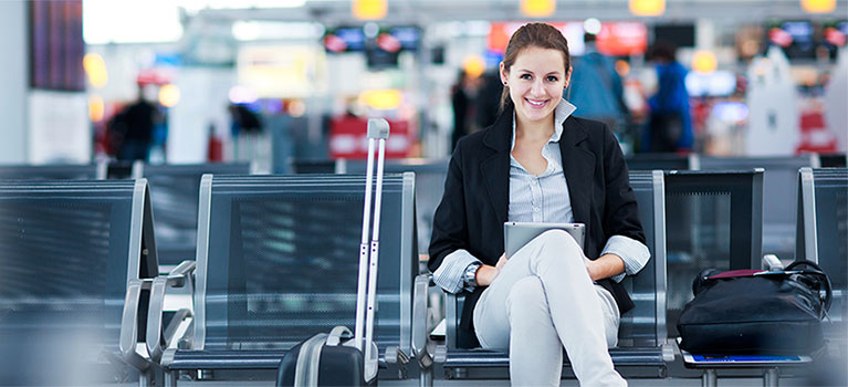 Young Caucasian woman with luggage waiting for her flight