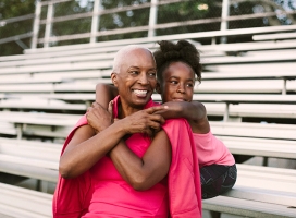 Grandmother and granddaughter sitting on bleachers (BLD222073)