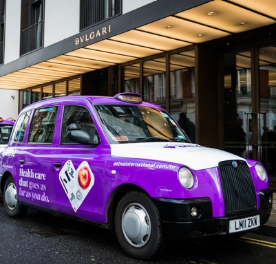 Two cabs clad in violet to raise awareness for Aetna International in central London