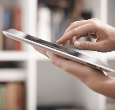 Woman holding digital tablet in library