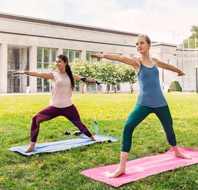 Young women doing yoga on a college campus