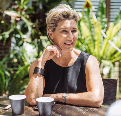 Businesswomen and businessmen discussing investment ideas over coffee