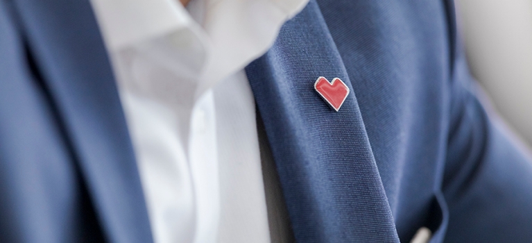 Blazer with an Aetna heart pin attached to it. 