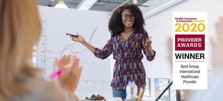 Businesswoman leading meeting at flip chart in conference room