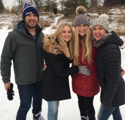 Yoga vlogger Andrea Niekerk and her family ice skating outdoors in Canada