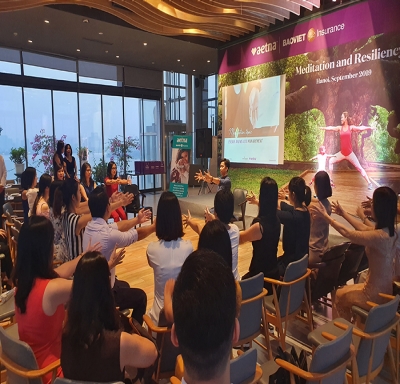 Aetna International broker partners and customers in Hanoi participating in breathwork and meditation sessions.