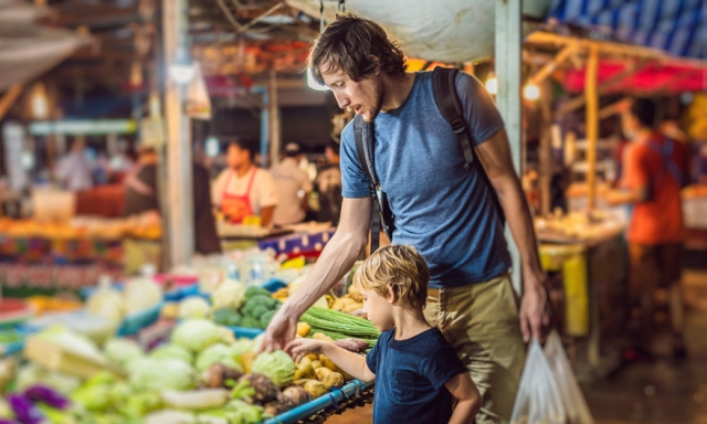 Father and son shopping for vegetables at an Asian market