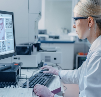 Female scientist analyzing DNA on her laboratory computer