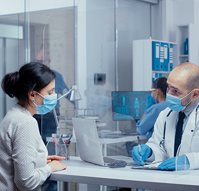 Patient and doctor wearing masks in a medical facility