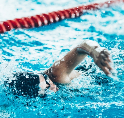 Caucasian woman swimming in an indoor pool