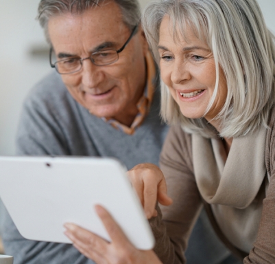 Senior adult couple looking at a tablet together