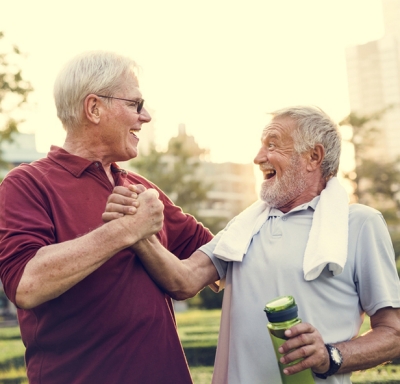 Active senior friends sharing a congratulatory handshake