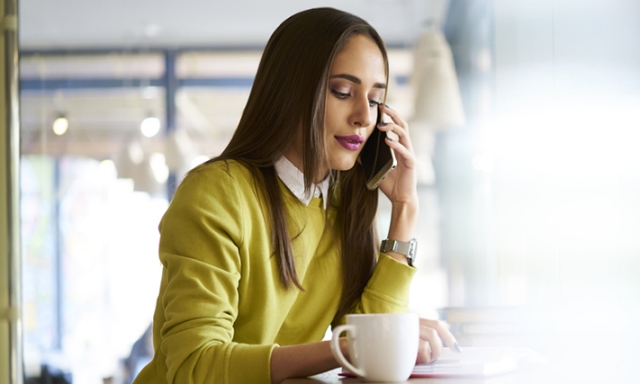 Young woman on phone working in cafe - Virtual Call Centre