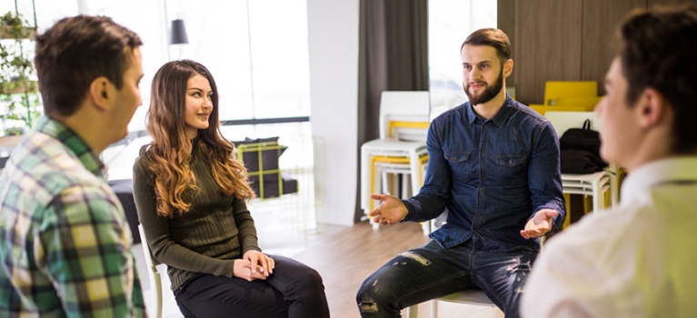 Group of young professionals talking in a group therapy session