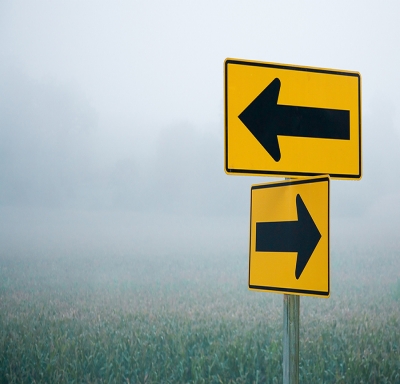 Road sign arrows pointing in different directions