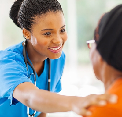 Nurse comforting senior patient in office