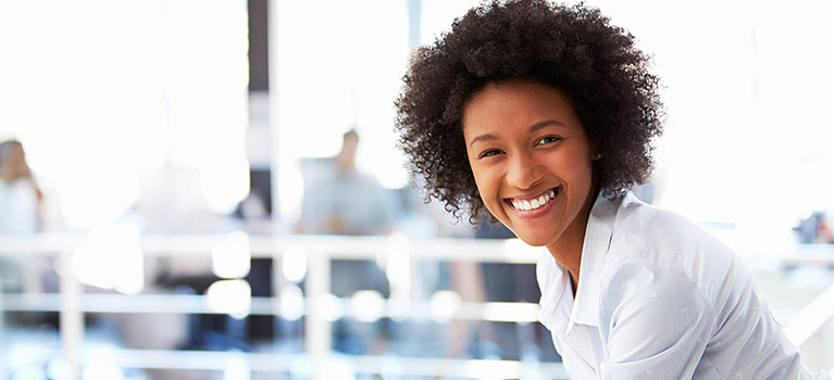 young woman leaning over railing, smiling