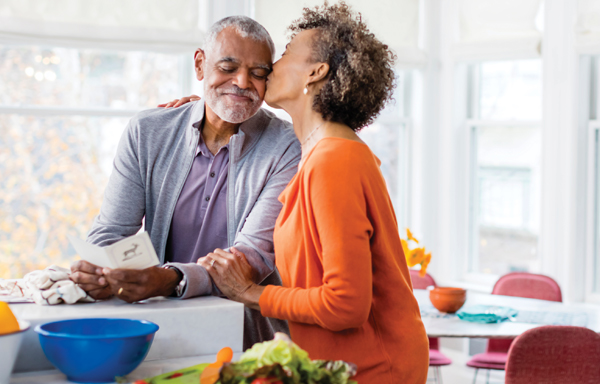 Woman and man in kitchen smiling