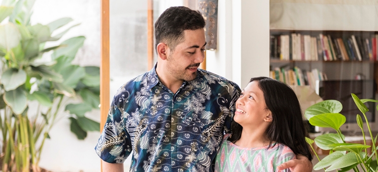 Man looking down on child smiling