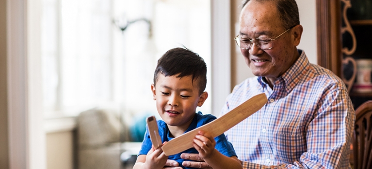 Man helping child assemble toy