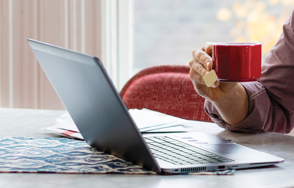 Holding cup over laptop