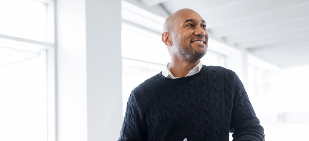 Man in a blue shirt and smiling