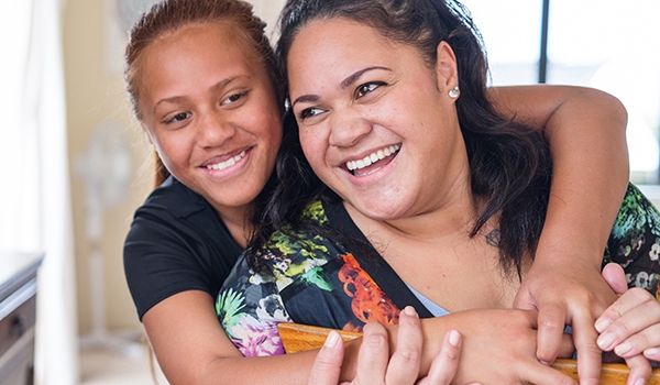 Two females hugging and smiling