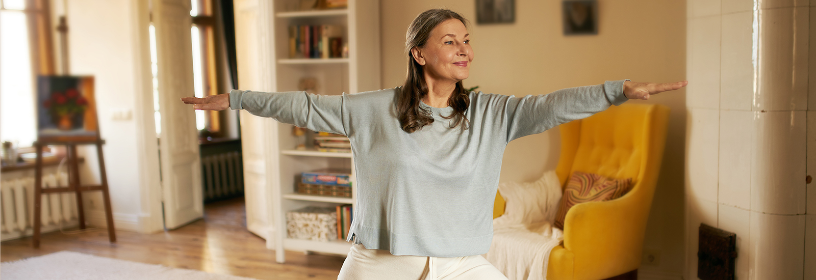 Woman in yoga clothes doing yoga in her living room