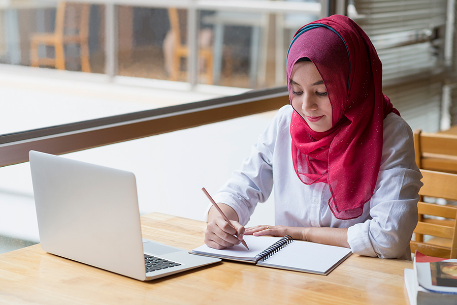 Indonesian woman studying with laptop