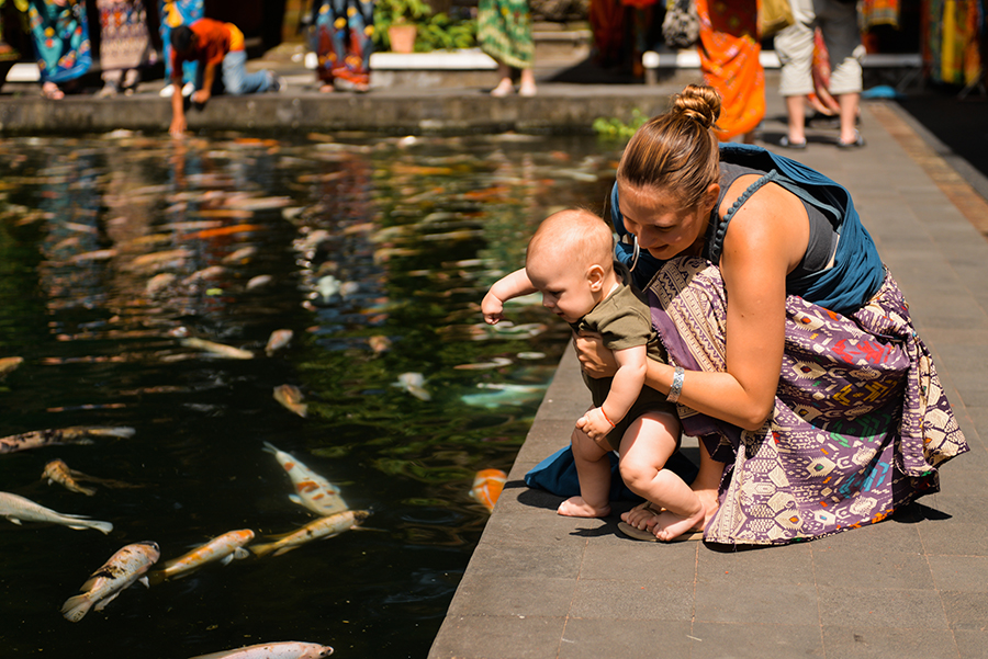 Woman and child looking at water in lake