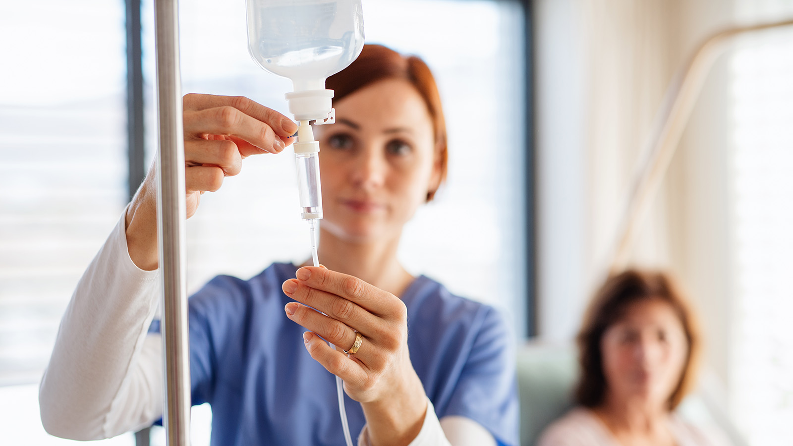 Nurse setting up an IV drip